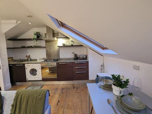 uma grande cozinha com um fogão e um lavatório em Fabulous Studio Retreat - Flat 4 Highbury em Londres