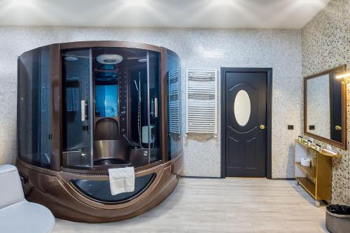 a bathroom with a large shower with a black door at Cron Palace kosher Tbilisi Hotel in Tbilisi City