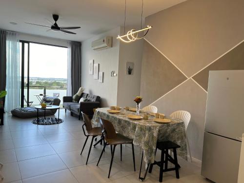 a kitchen and living room with a table and chairs at Gala City best place gala residence in Kuching