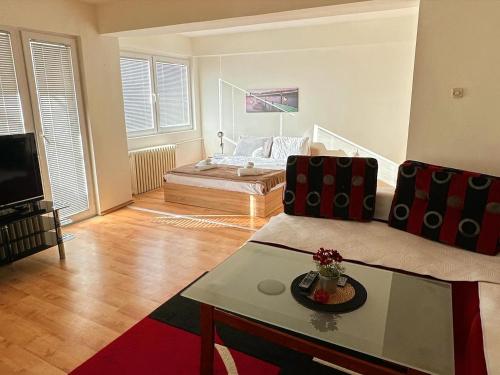 a living room with a couch and a bed at Aleks 4 in Skopje