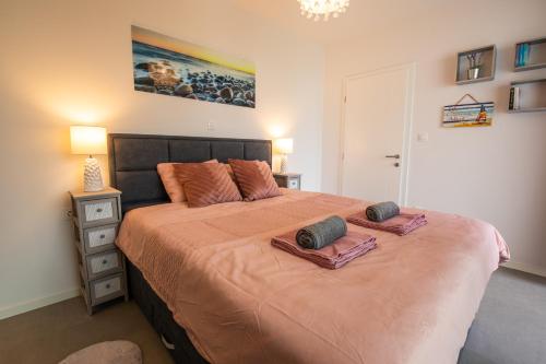 a bedroom with a large bed with two pillows on it at Luxury Apartment Marija in Novalja