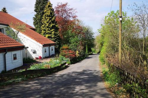 an empty road with houses and trees on either side at Ferienhaus Auszeit in Meinerzhagen