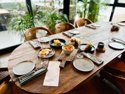 a wooden table with plates of food on it at Khedi Hotel Tbilisi in Tbilisi City