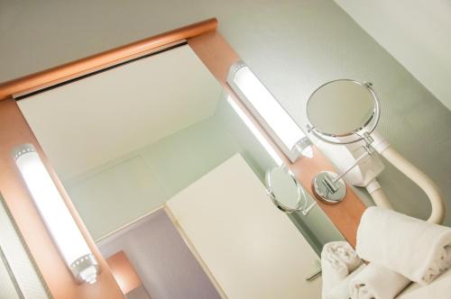 a mirror in a room with a bed and a mirror at ibis Montpellier Centre Comedie in Montpellier
