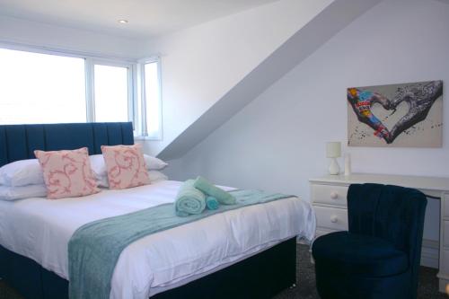 a bedroom with a bed and a blue chair at The Birmingham Boutique in Birmingham