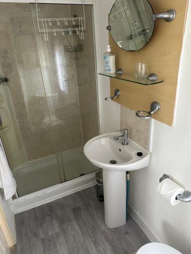 a bathroom with a sink and a shower at Static Mobile home set in our 20 acres of farmland in Horspath