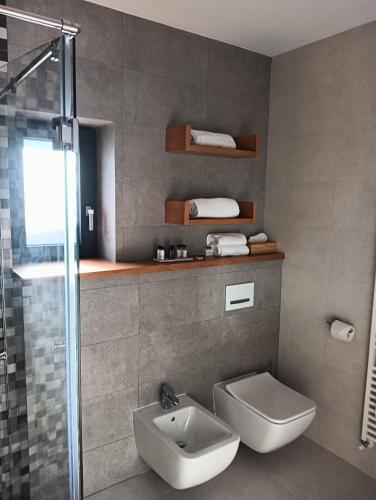 a bathroom with a toilet and a sink and a shower at Anais Chalet in Câmpulung Moldovenesc