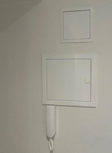 a white wall with a urinal on a wall at Premium Apartment in quiet & historical area in Rīga