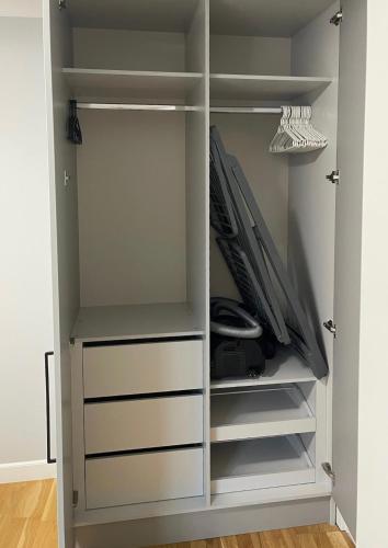 a closet with white doors and drawers at Premium Apartment in quiet & historical area in Rīga