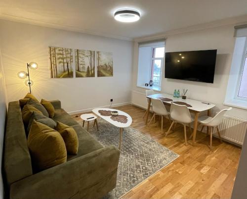 a living room with a couch and a table at Premium Apartment in quiet & historical area in Rīga