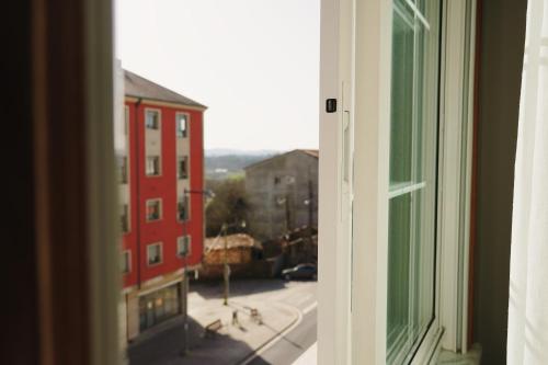 an open window with a view of a city street at Rosende VUT in Arzúa