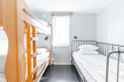 a bedroom with two bunk beds and a window at Vimmerby Camping in Vimmerby