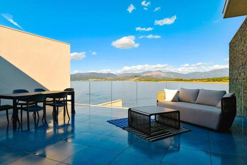 a living room with a couch and a table at Le Galatée ,T2 luxe pieds dans l'eau in Porticcio