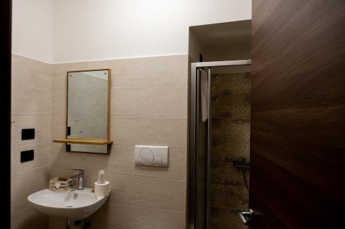 a bathroom with a sink and a mirror at La Villetta Food & Drink Rooms for Rent - No Reception - in LʼAquila