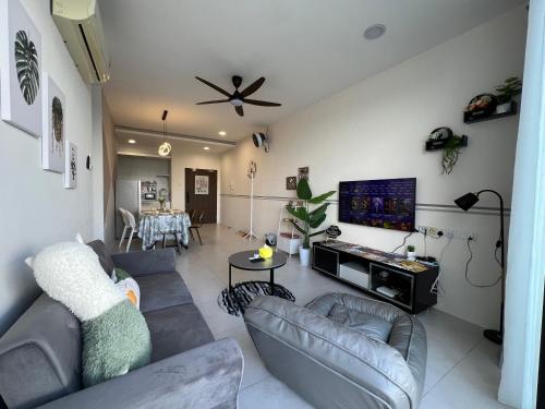 a living room with couches and a flat screen tv at Gala City best place gala residence in Kuching