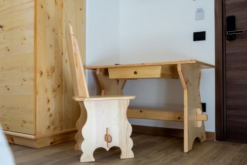 a wooden desk with a chair next to a table at La Villetta Food & Drink Rooms for Rent - No Reception - in LʼAquila