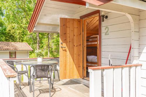 a patio with a table and chairs on a deck at Vimmerby Camping in Vimmerby