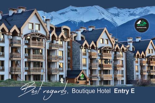 a picture of a hotel with mountains in the background at BOUTIQUE Hotel ENTRY E in Bansko