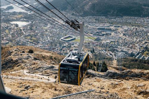 a gondola flying over a city on a mountain at Quality Hotel Edvard Grieg in Bergen