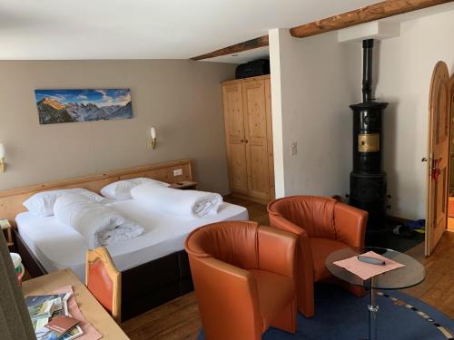 a hotel room with two beds and a fireplace at Hotel Spöl Restaurant in Zernez