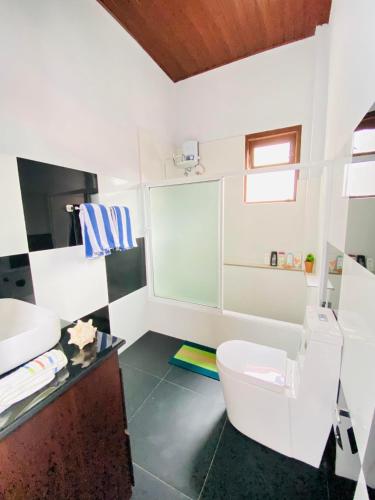 a bathroom with a toilet and a sink at Erin Orr Villa in Wadduwa