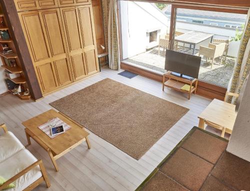 a living room with a large window and a table at Bodenseeblick in Konstanz