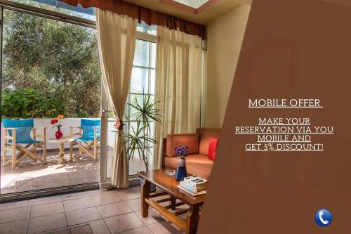 a living room with a couch and a table at Hotel Dionysis Studios in Adamas