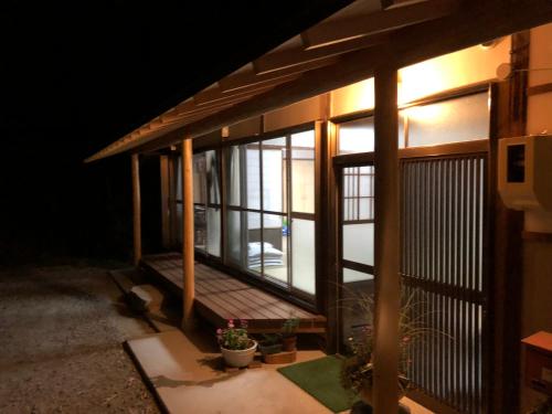 a view of a house with a porch at night at Vacation Rental あんばええ in Nakatsugawa