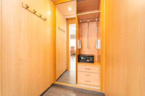 a hallway with a door leading into a room with a microwave at Vistamar Hotel Luxury Wellness By DLV -Adults Only- in Villajoyosa