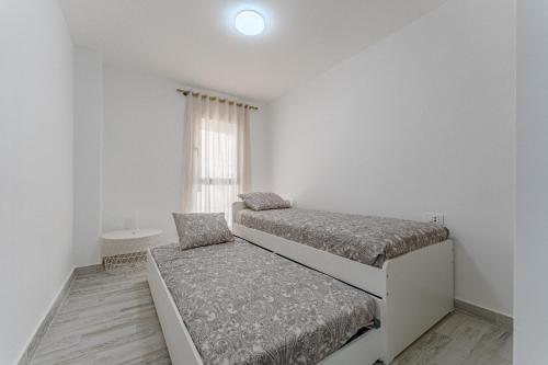 a bedroom with two beds and a window at TULUM MEDANO BEACH in El Médano