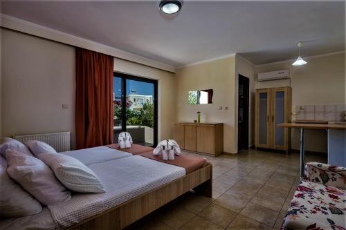 a bedroom with a large bed and a window at XENOS VILLA 2 with a private pool,near the sea in Tigaki