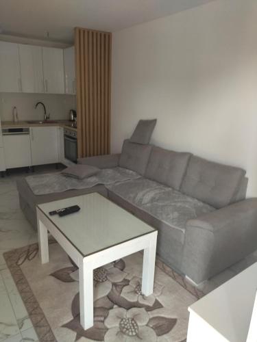 a living room with a couch and a coffee table at Ivan apartmani Posušje in Posušje