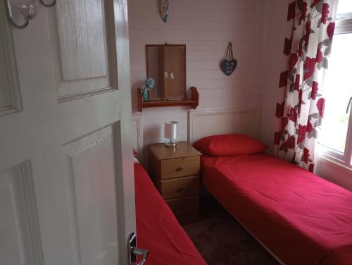 a small room with two beds and a window at Sea views in Bideford