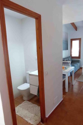 a bathroom with a toilet and a sink at Biniplaya - Apartamento reformado al lado de la playa in Arenal d'en Castell