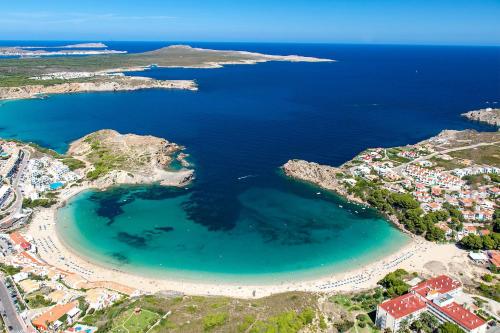 an aerial view of a beach and the ocean at Biniplaya - Apartamento reformado al lado de la playa in Arenal d'en Castell