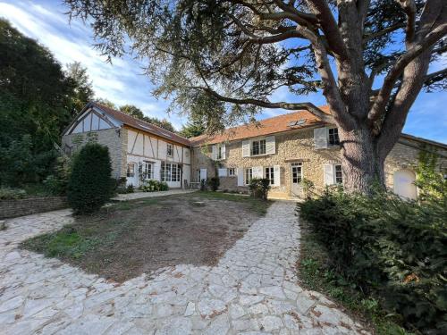 a house with a tree and a stone driveway at Le Clos Ste Thérèse by Idylliq 