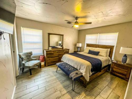 a bedroom with a bed and a chair at Cozy, Fam Friendly Home Min from Stkyards in Fort Worth