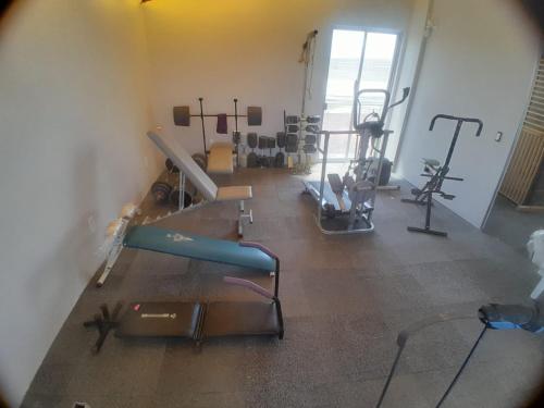a gym with several exercise equipment in a room at Casa Bosques in Cuautitlán Izcalli