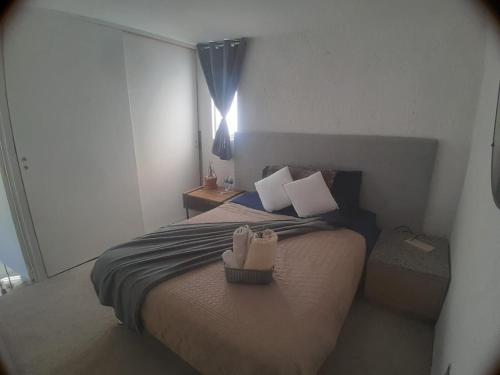 a bedroom with a bed with shoes on it at Casa Bosques in Cuautitlán Izcalli