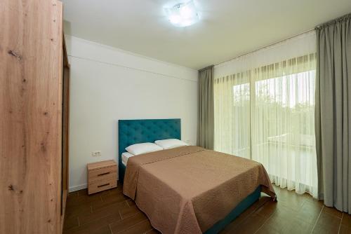 a bedroom with a bed and a large window at Adria lux apartmens 2 in Sveti Stefan