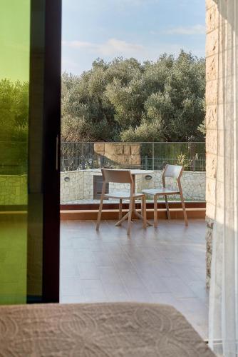 a patio with two chairs and a table on a balcony at Adria lux apartmens 2 in Sveti Stefan