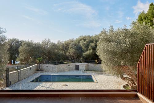 a swimming pool on the patio of a house at Adria lux apartmens 2 in Sveti Stefan