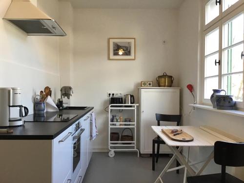 a kitchen with a counter and a table in it at Haus vor dem Schöneberger Tor in Hofgeismar