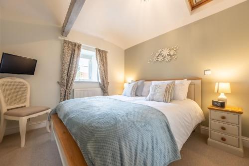 a bedroom with a large bed and a window at The Clockhouse in North Lopham
