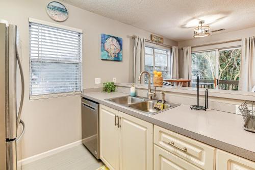 a kitchen with a sink and a refrigerator at Myrtle Beach Retreat with Balcony Near Boardwalk! in Myrtle Beach