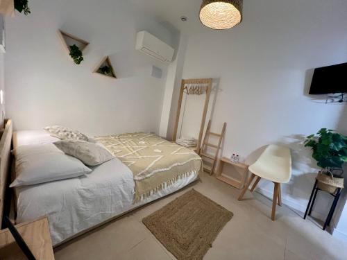 a bedroom with a bed and a mirror and a tv at Niña Mala in Valencia
