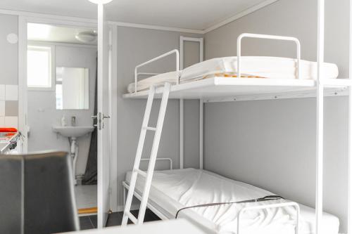 a room with two bunk beds and a ladder at Vimmerby Camping in Vimmerby