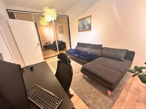 a living room with a couch and a table with a laptop at Apartament Anca in Sibiu