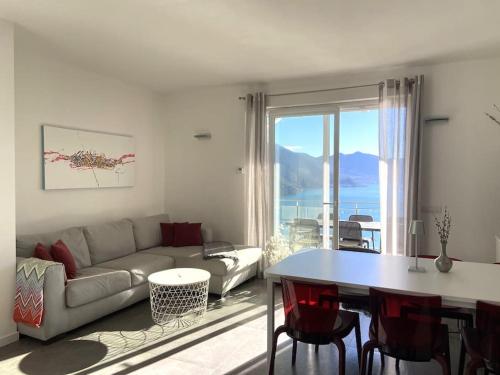 a living room with a couch and a table at La casa sulla collina vista lago in Riva di Solto