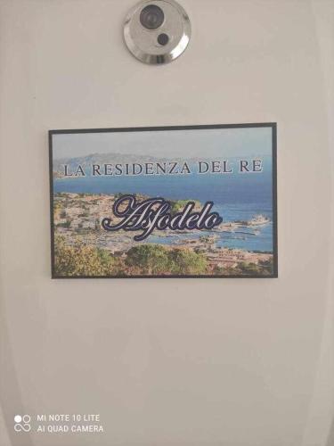 a picture of a sign hanging on a wall at La Residenza del Re! in Palau